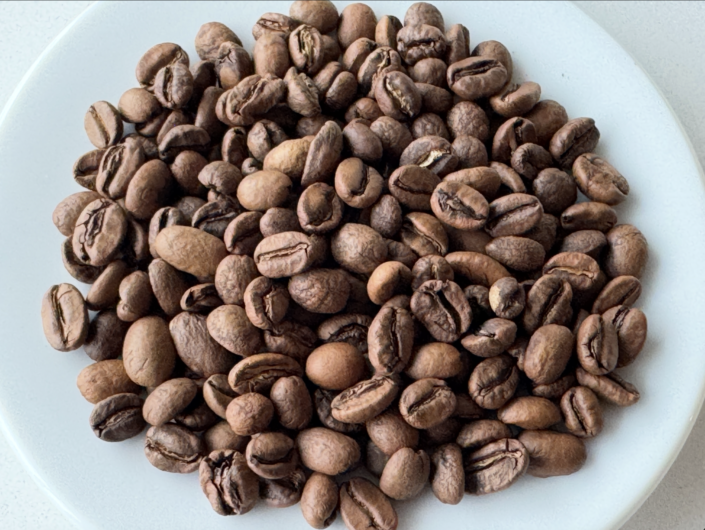 coffee-beans-on-white-plate.png